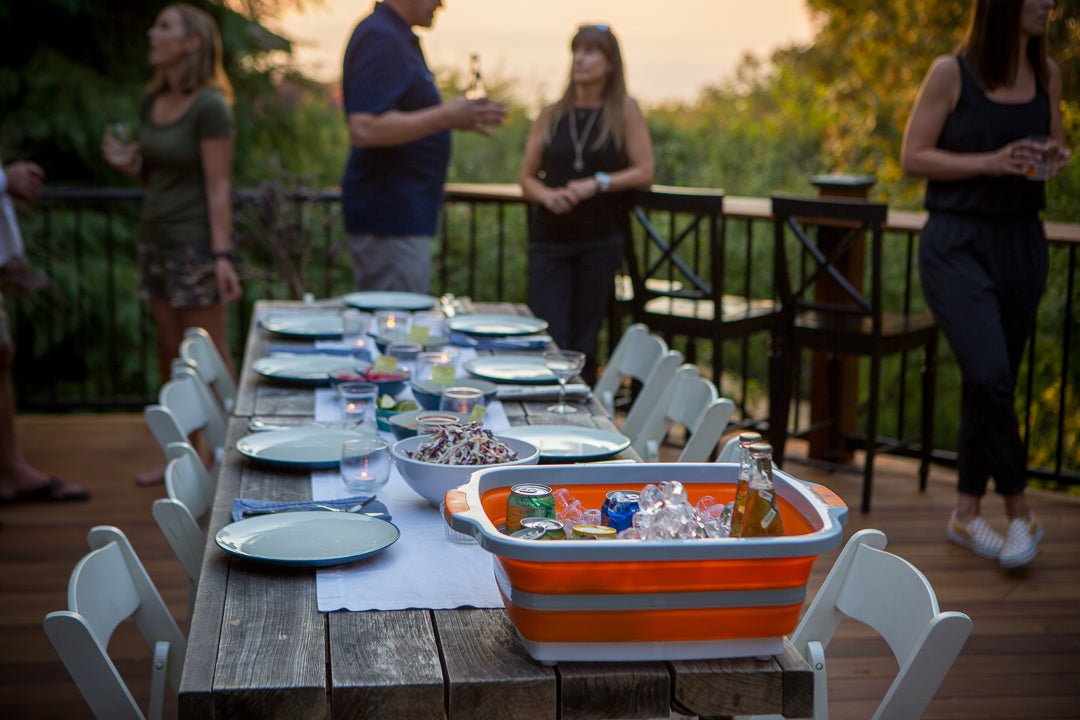 BBQ prep table with built-in cutting board and food setup for outdoor gathering