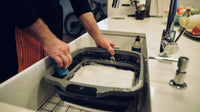 Dishwasher cleaning of BBQ prep tub with foam