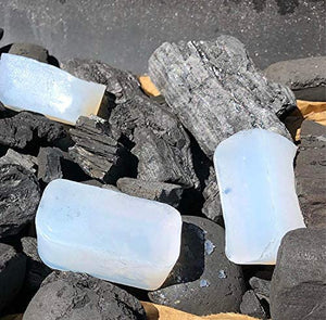 White solid firelighter blocks on charcoal