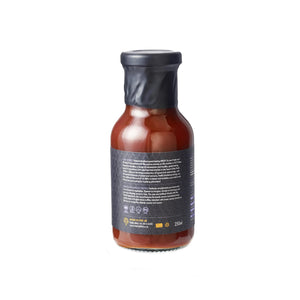 Back label of Firefly Black Truffle BBQ Sauce bottle showing ingredients and certifications like vegetarian and halal-friendly.