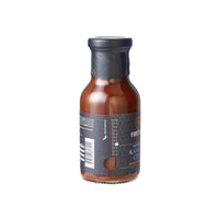 Side view of Firefly BBQ Kansas Brisket BBQ Sauce bottle showing spice level indicator and sleek black label design for gourmet grilling.