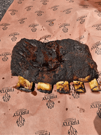 Cooked beef ribs on OREN Pink Butchers Paper Roll - BBQ Meat Smoking | FDA Approved, showcasing bark development and paper durability post-smoke.