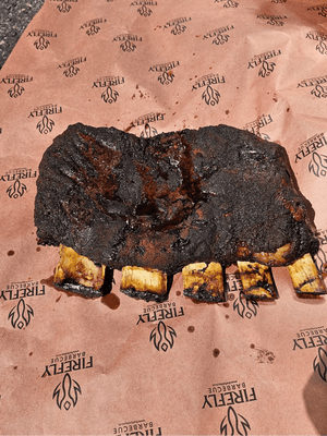 Cooked beef ribs on OREN Pink Butchers Paper Roll - BBQ Meat Smoking | FDA Approved, showcasing bark development and paper durability post-smoke.