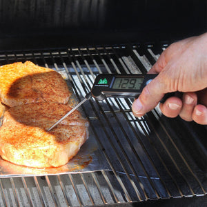 GMG Digital Probe Thermometer - FireFly Barbecue in use on grill, measuring internal temperature of seasoned pork chops for perfect doneness.