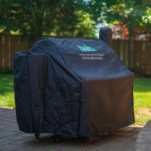 GMG Grill Full-Length Cover shielding Green Mountain Grill in garden, premium outdoor grill cover for all-weather use - FireFly Barbecue