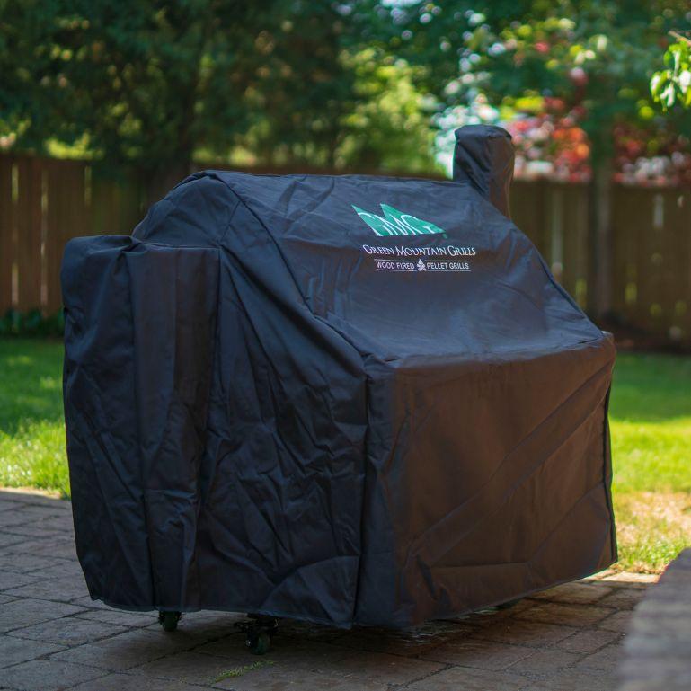 GMG Grill Full-Length Cover shielding Green Mountain Grill in garden, premium outdoor grill cover for all-weather use - FireFly Barbecue