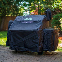 Protective GMG Grill Full-Length Cover on Green Mountain Grill with wheels, designed for backyard BBQ setups - FireFly Barbecue