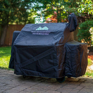 Protective GMG Grill Full-Length Cover on Green Mountain Grill with wheels, designed for backyard BBQ setups - FireFly Barbecue