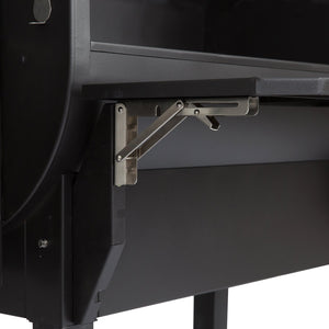 Detail of GMG LEDGE PRIME collapsible front shelf bracket, offering sturdy support and space-saving design for outdoor grilling setups.
