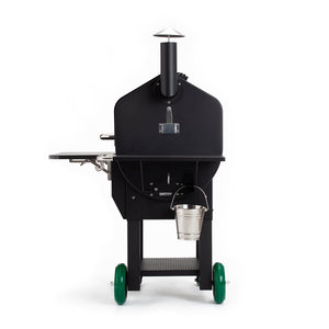 Side view of GMG PEAK Prime wood pellet smoker with chimney, bucket hook, and foldable side shelf for outdoor grilling convenience.