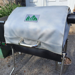 GMG Thermal Blanket - FireFly Barbecue in silver color on a grill, ideal for maintaining temperature during cold outdoor grilling sessions.