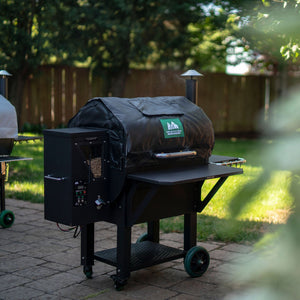 GMG Thermal Blanket - FireFly Barbecue in black, covering a grill in a backyard, perfect for energy-efficient winter barbecuing.