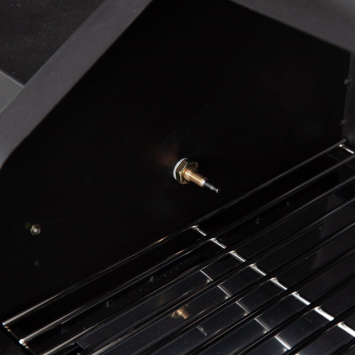 Interior probe mount of GMG Trek Portable BBQ Grill - FireFly Barbecue for accurate temperature monitoring during grilling.