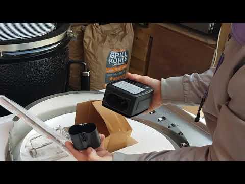 Monolith Classic Rotisserie - FireFly Barbecue unboxing showing battery-operated motor. Durable motor fits into rotisserie ring for grilling.