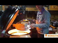 User placing Monolith Wok Stand Stainless Steel on ceramic grill, showcasing setup for concentrated heat cooking with wok.