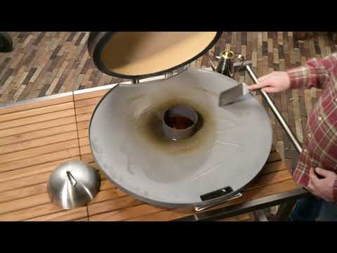 Monolith Fire Plate - LeCHEF being seasoned with oil on Monolith grill, demonstrating preparation before first use for optimal performance.