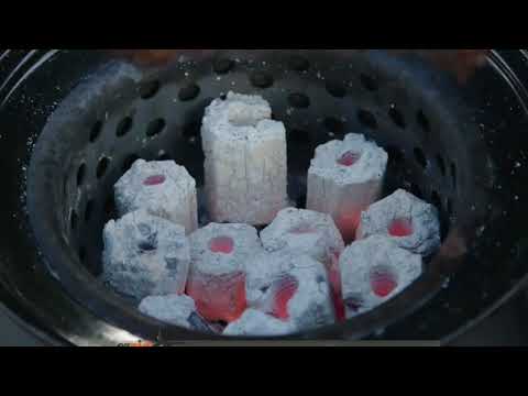 Close-up of glowing charcoal briquettes in Ozpig heat bead basket, part of Ozpig Rotisserie Kit - FireFly Barbecue setup.