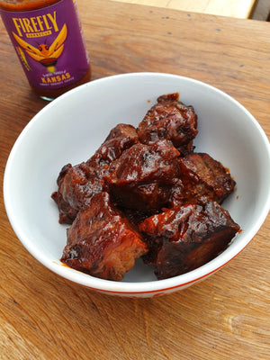 Bowl of juicy beef burnt ends glazed with Firefly BBQ Kansas Brisket BBQ Sauce, showcasing its thick, sweet, and smoky Kansas City flavor.