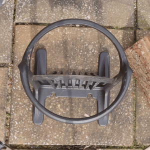 Top-down view of Kindling Cracker Original placed on stone surface, showing circular safety ring and splitting blades for safe wood processing.