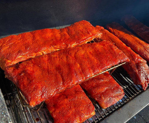 Grilled ribs with BBQ sauce on grill