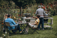 Outdoor grilling setup with Monolith BBQ and add-on table in garden