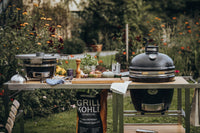 Garden barbecue scene with Monolith grill and food ingredients