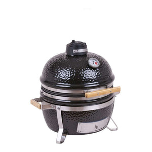 Angled view of MONOLITH Icon Portable Kamado Grill with closed lid, highlighting compact design and integrated temperature gauge.