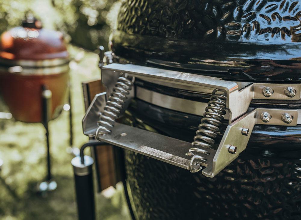 Kamado grill with metal hinge and adjustable air vent