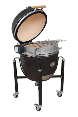 Angled view of Monolith LeChef Rotisserie installed on kamado grill with skewers, perfect for outdoor cooking