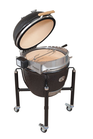 Monolith LeChef Rotisserie on kamado grill with lid open, featuring motorized spit for roasting meats