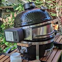 Black ceramic coated rotisserie lid with temperature gauge for outdoor cooking