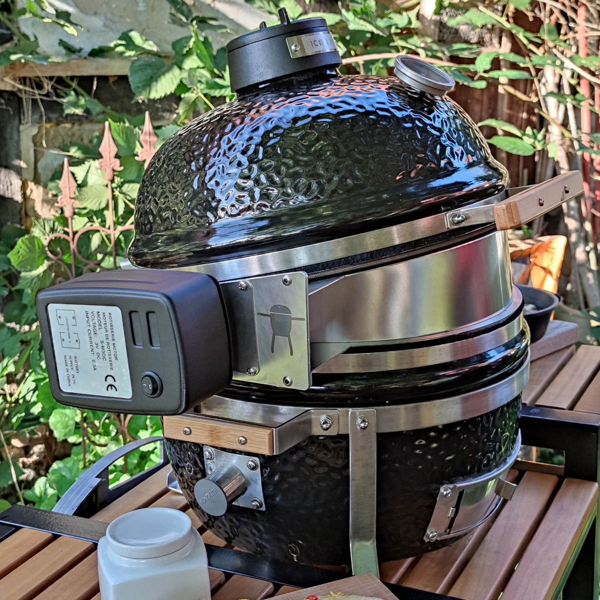 Black ceramic coated rotisserie lid with temperature gauge for outdoor cooking