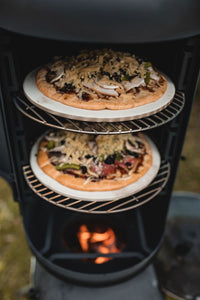 Ozpig Oven Pizza Stone - Perfect Crusts | Easy Cooking. Two pizzas baking on Ozpig pizza stones inside a vertical smoker for crispy, evenly cooked bases.