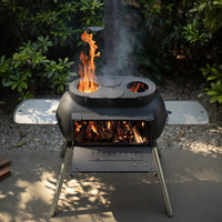 Top view of Ozpig Big Pig outdoor stove with dual cooking plates and visible flames, perfect for backyard grilling.
