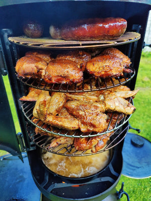 OzPig Oven Smoker filled with grilled meats on multiple racks. High-capacity outdoor smoker for BBQ, roasting, and slow cooking.