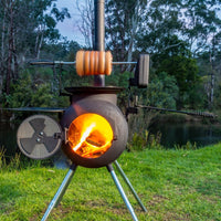 Ozpig Rotisserie Kit - FireFly Barbecue in use outdoors, roasting meat over open flame on Ozpig Series 2 for wood-fired cooking.