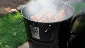 Pit Barrel PBX 22.5 Cooker smoking whole chickens outdoors, emphasizing its 360º heat dynamics and flavor infusion.