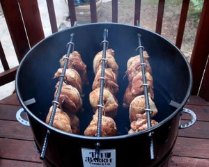 Pit Barrel PBX 22.5 Cooker filled with whole chickens hanging on rods, perfect for large outdoor BBQ gatherings.
