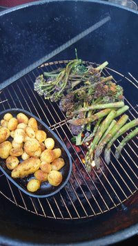 Grilled vegetables and potatoes on Pit Barrel Cooker in outdoor backyard