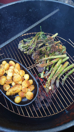 Grilled vegetables including asparagus and potatoes on the Pit Barrel PBX 22.5 Cooker grill grate, showing versatile cooking options.