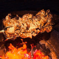 Rotisserie chicken roasting on BBQ with Primo Rotisserie Kit