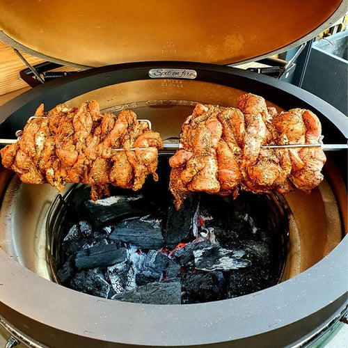 Rotisserie cooking chicken on ceramic BBQ with Primo Rotisserie Kit