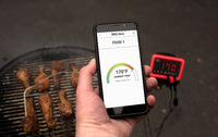 Smartphone displaying UltraQ BBQ Guru app with food temperature at 170°F, enabling real-time grill monitoring via Wi-Fi or Bluetooth.
