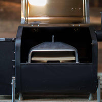 GMG Wood-Fired Pizza Attachment installed inside a GMG pellet grill, showcasing its compact fit and dual-layer stone design for even cooking.
