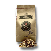 Cherry wood smoking chips in paper bag with chips and pile of wood chips